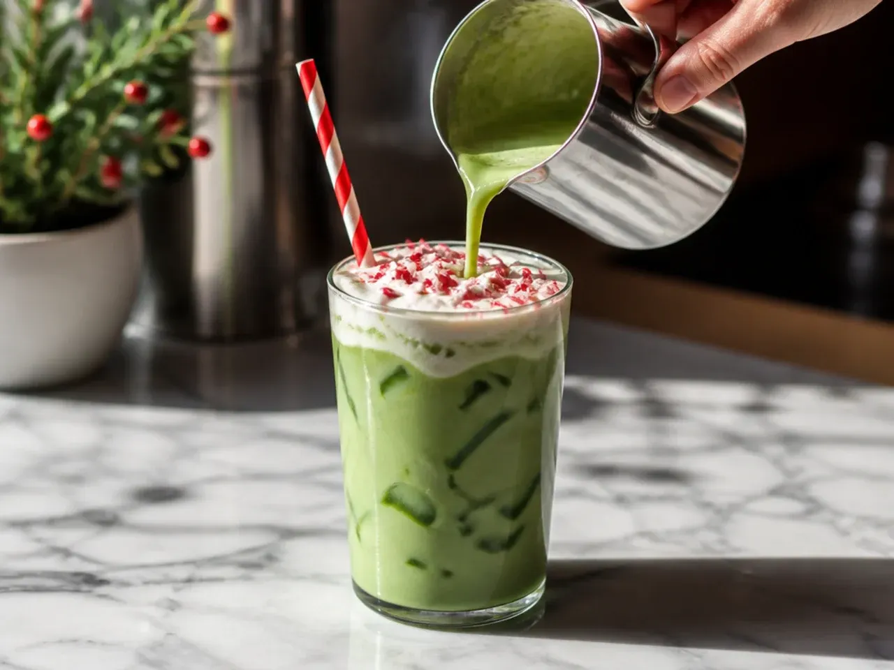 Festive peppermint matcha latte garnished with crushed candy cane on top of cold foam