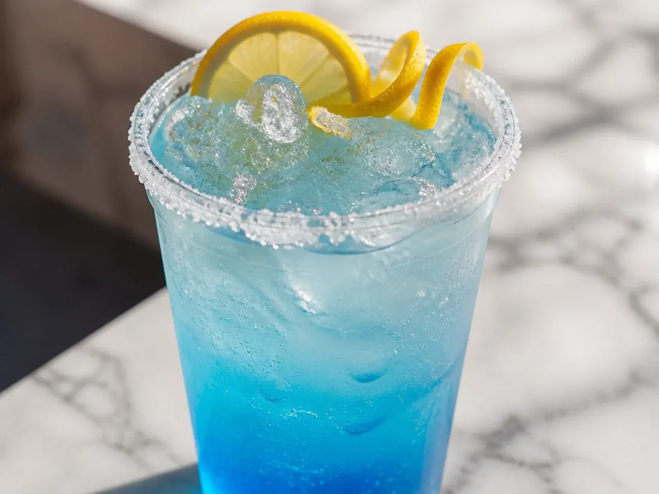 Turquoise copycat Ocean Water fizz drink with coconut and blue raspberry syrup in a clear cup