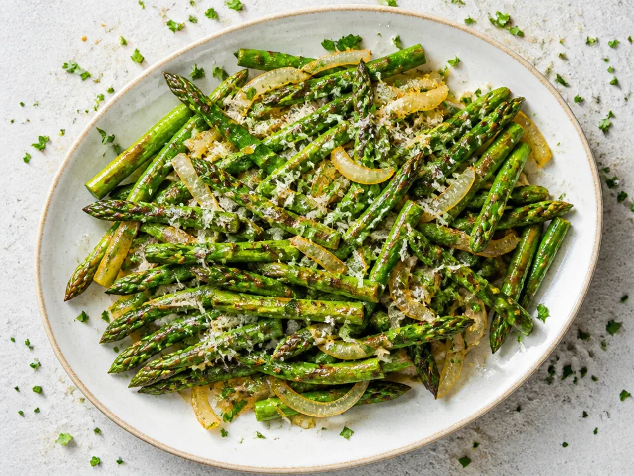 Asparagus and caramelised onions together in a skillet