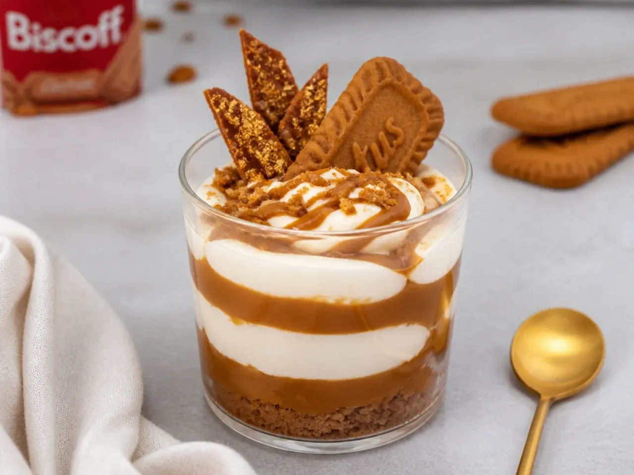 Elegant biscoff mascarpone parfait cups with striped melted spread and gold-dusted biscuit shards