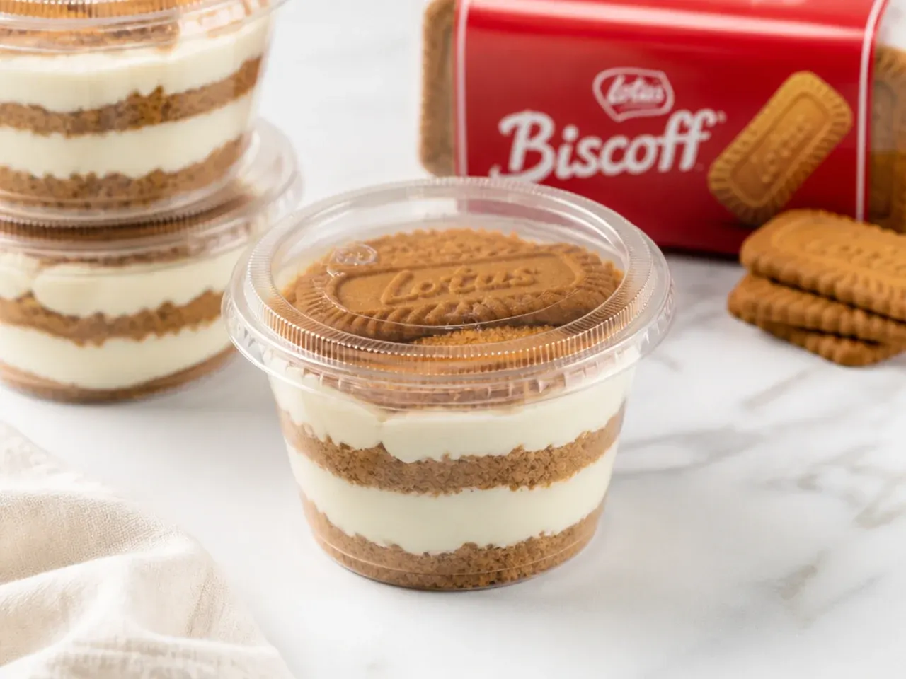Biscoff cheesecake cups covered with lids for storage in the refrigerator