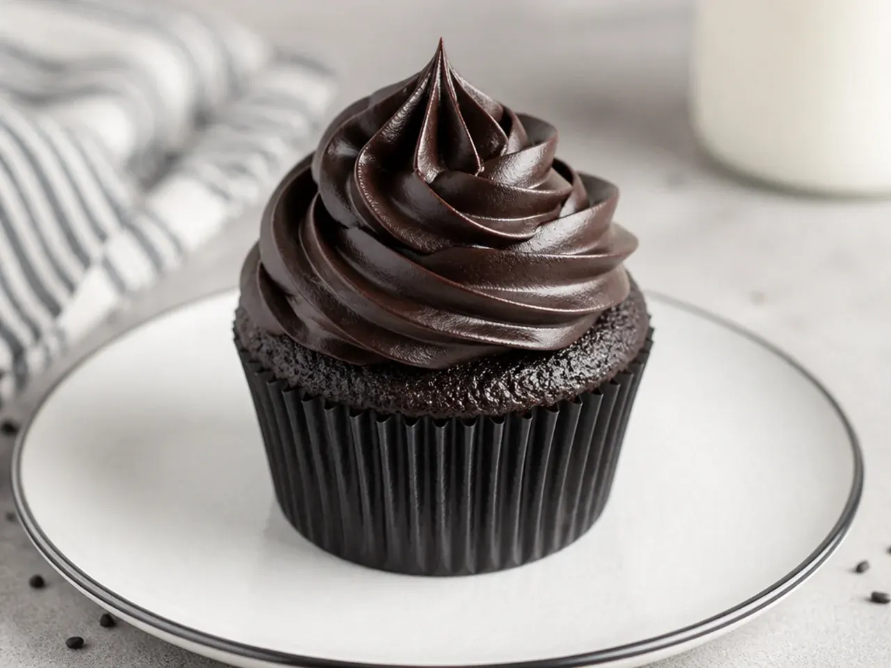 Classic black cupcakes topped with tall black cocoa buttercream swirls