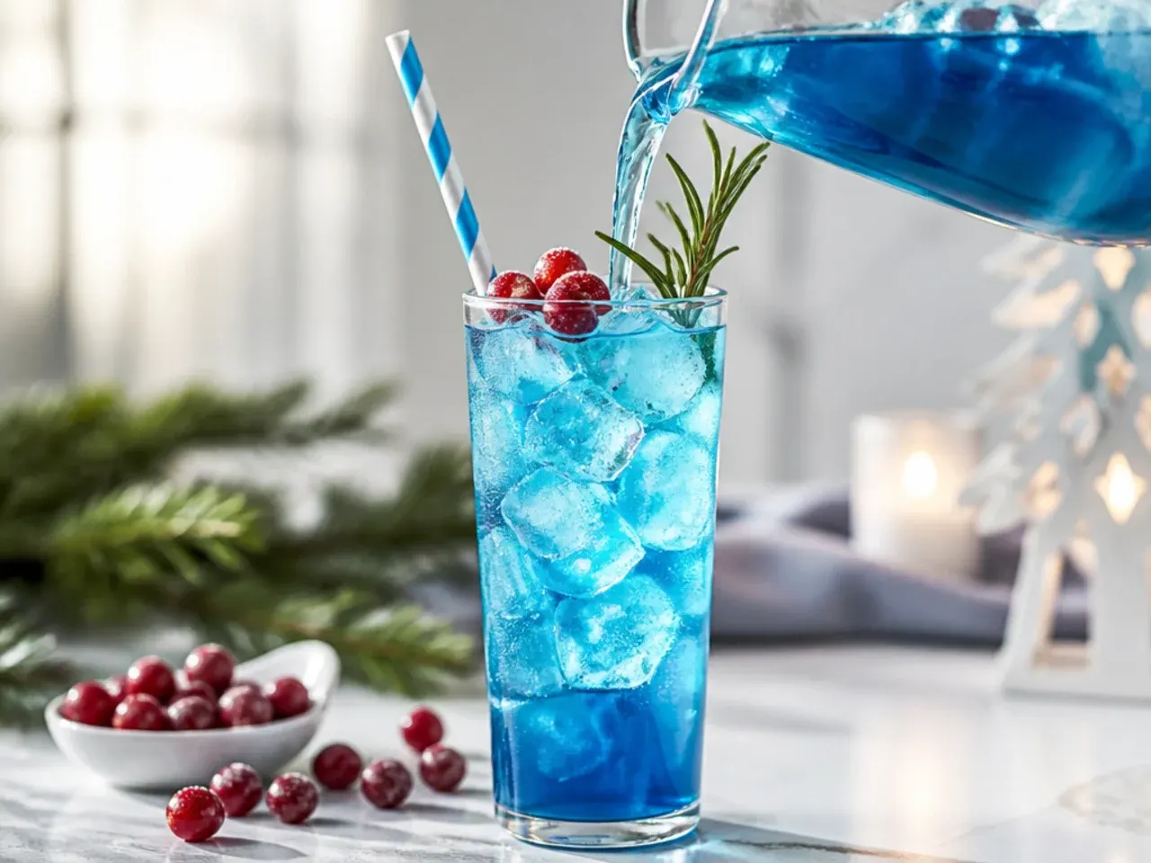Large bowl of festive blue winter punch with floating citrus wheels and an ice ring