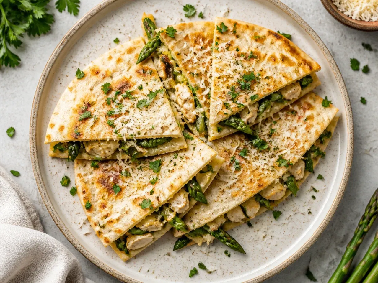 Crispy chicken and asparagus quesadilla sliced into wedges