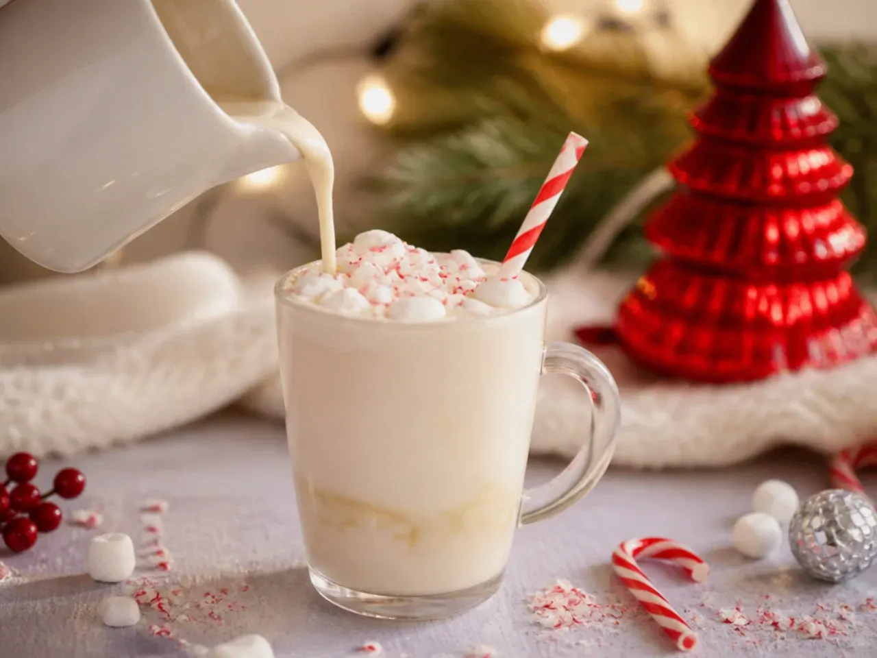 Creamy white hot chocolate in a mug topped with whipped cream and white chocolate shavings
