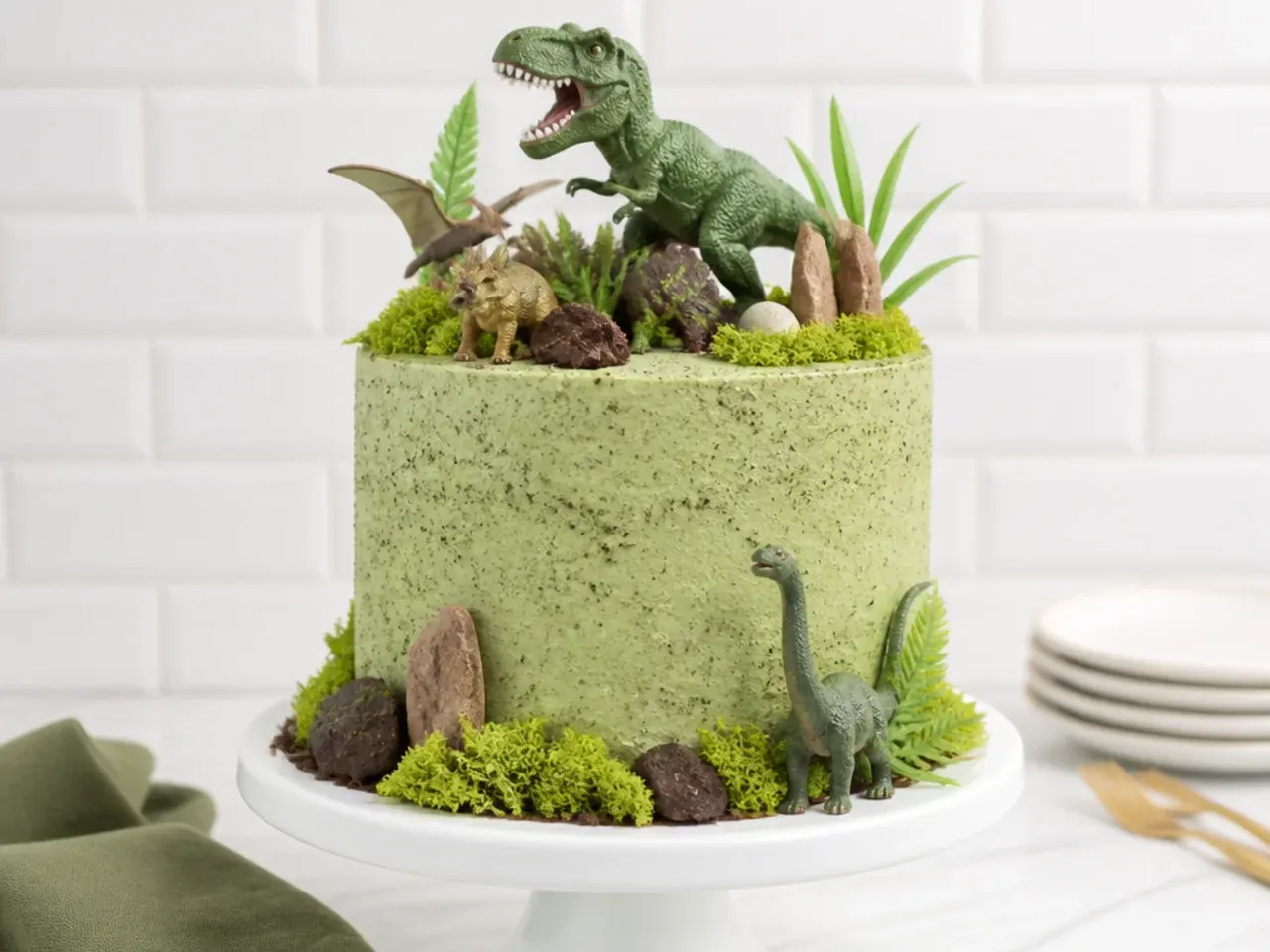 Tips for easier dinosaur cake designs with crumb coating and toppers