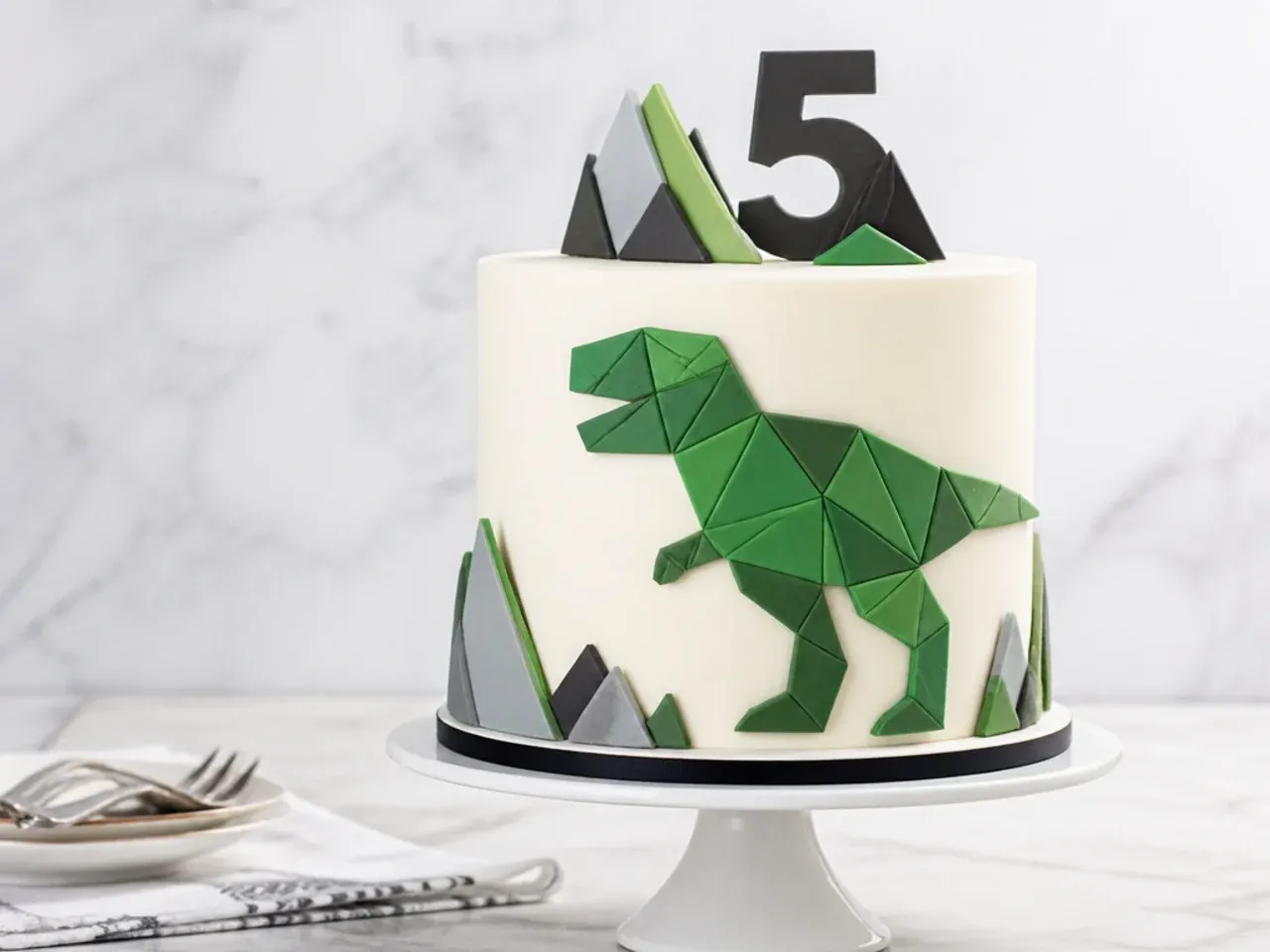 Modern geometric fondant dinosaur cake with low-poly T-Rex silhouette