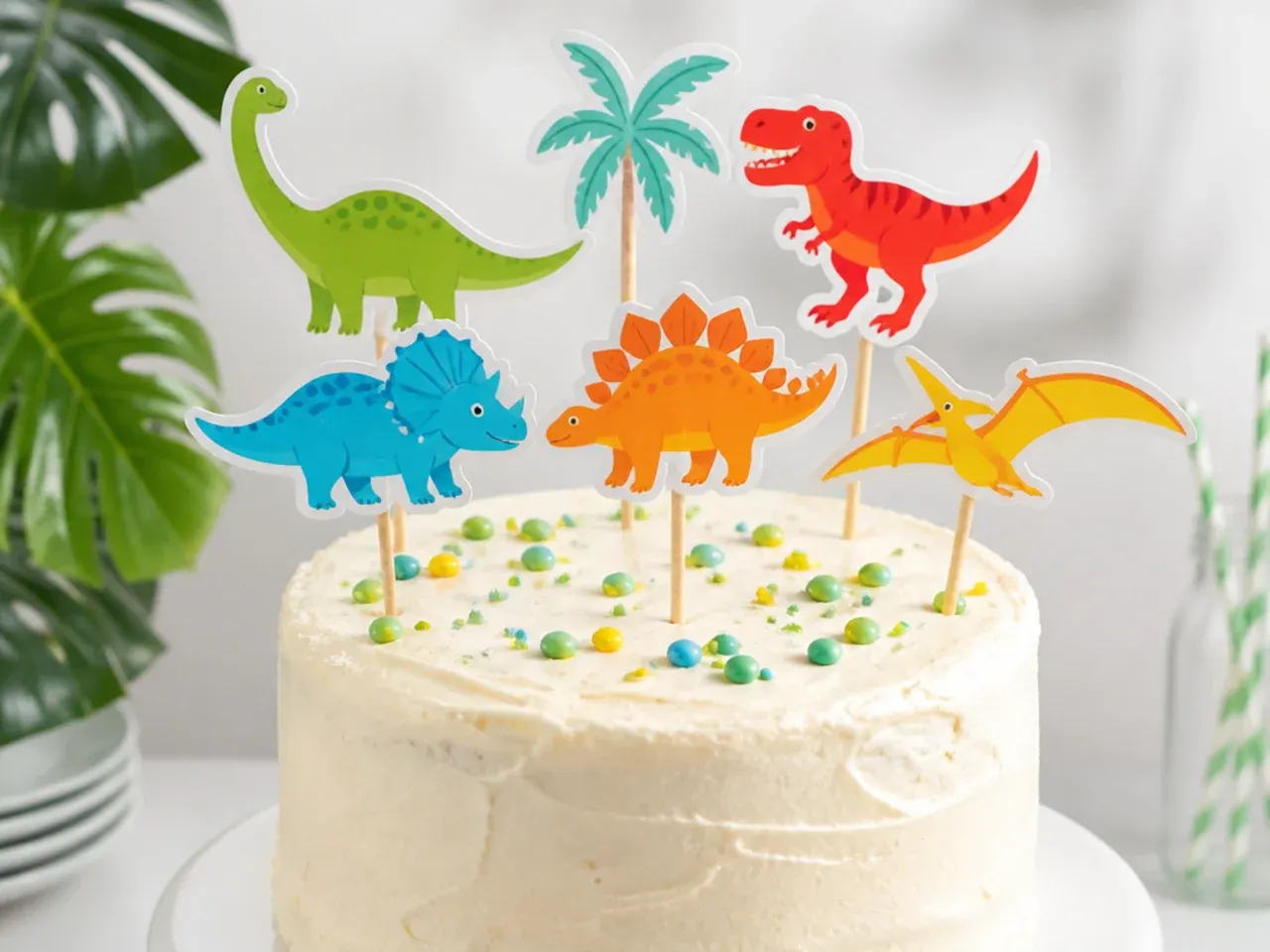 Easy printable dinosaur cake topper on wooden sticks in party colors