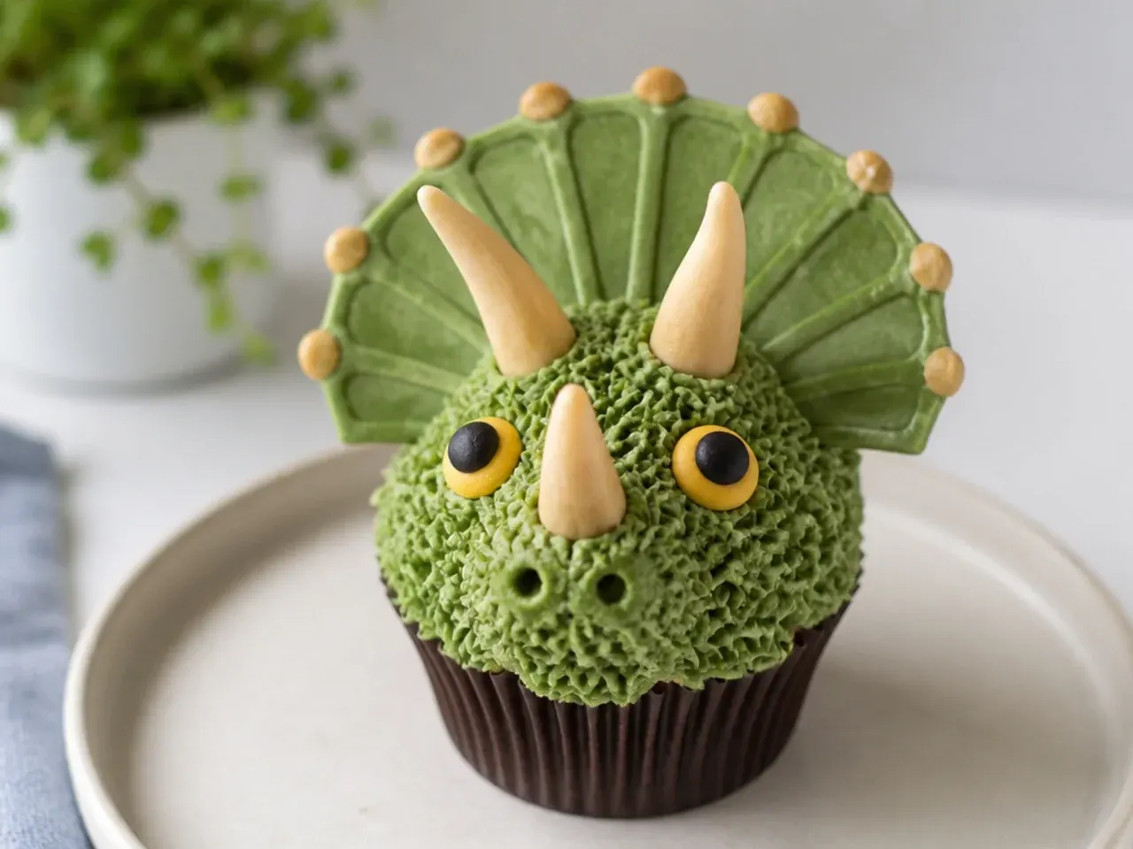 Triceratops dinosaur cupcakes with three horns and a fondant frill