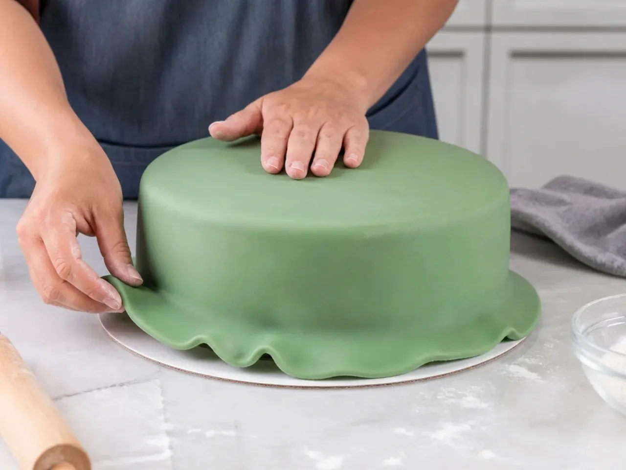 dinosaur fondant cake — step 3: cover the cake in green fondant