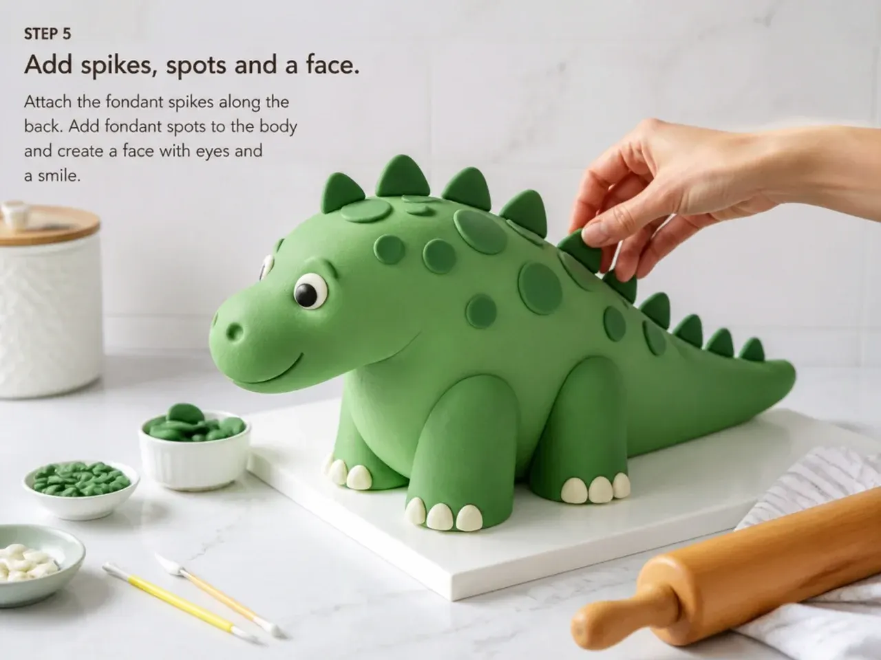 dinosaur fondant cake — step 5: add spikes, spots and a face