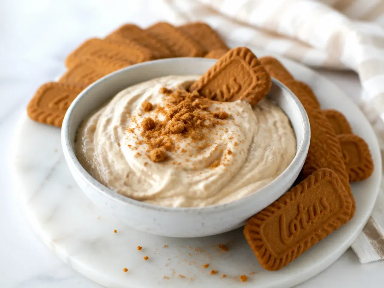 Easy Biscoff cheesecake dip in a bowl with biscuits for dunking