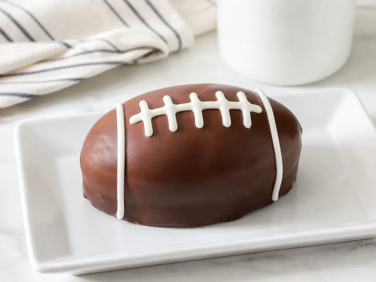 Charming mini football cakes made from loaf cakes dipped in chocolate with piped laces