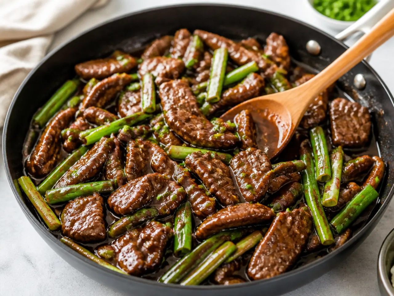 Quick easy Mongolian beef stir fry cooking in a single skillet
