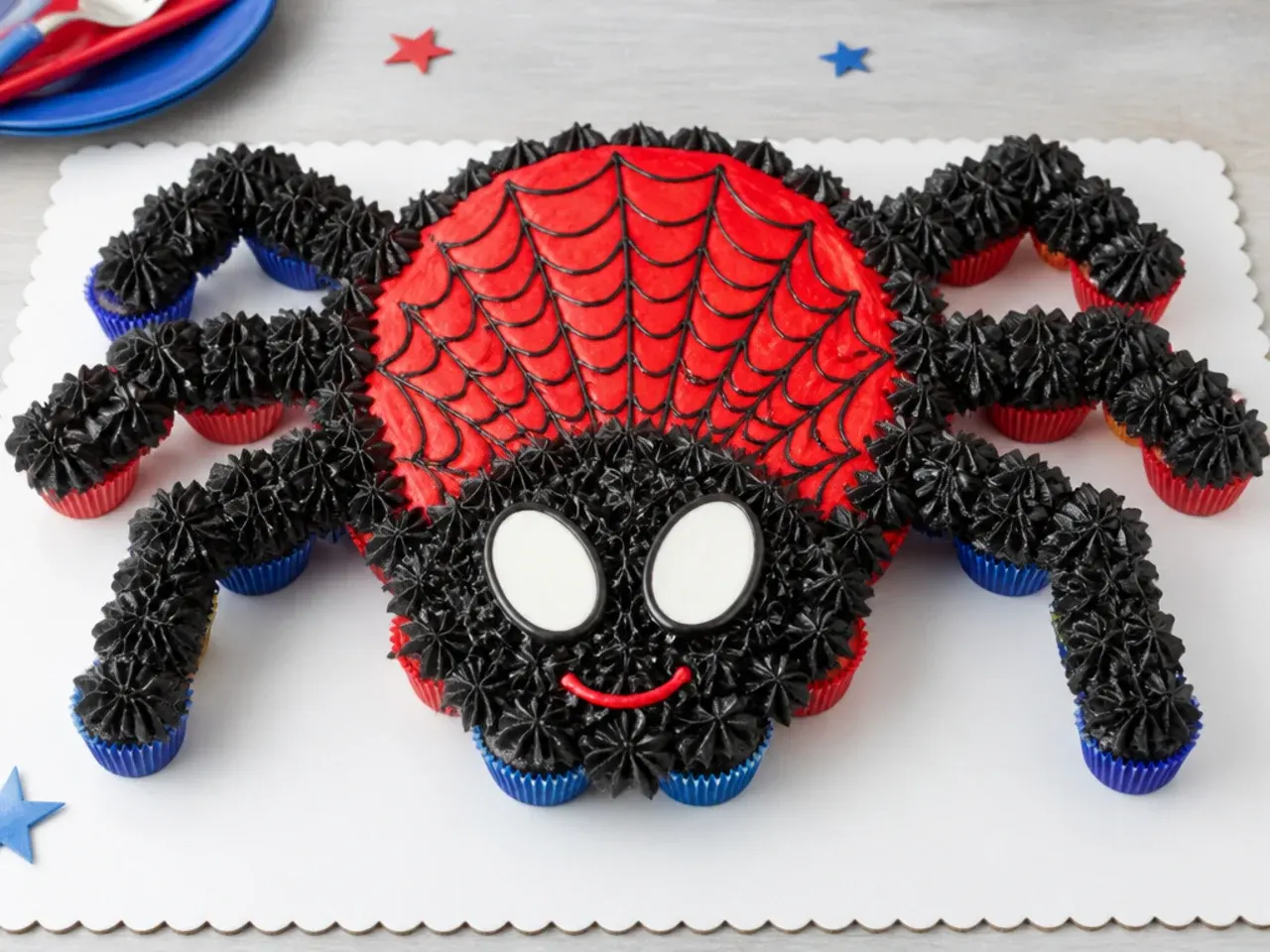 Whimsical Spiderman party pull apart cupcake cake shaped like a friendly spider