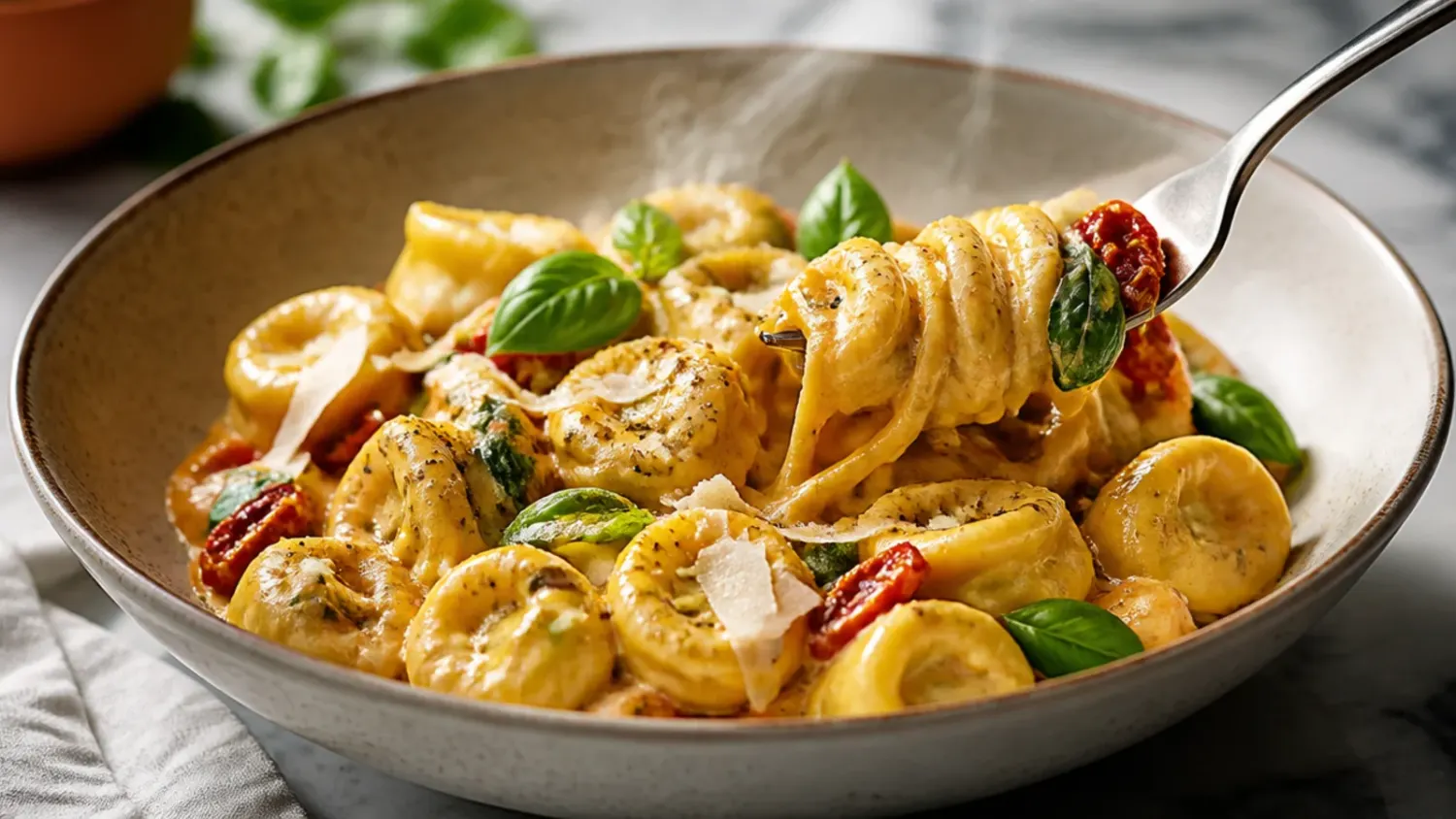 A bowl of creamy sausage tortellini soup with spinach and grated Parmesan, steam rising, on a rustic wooden table