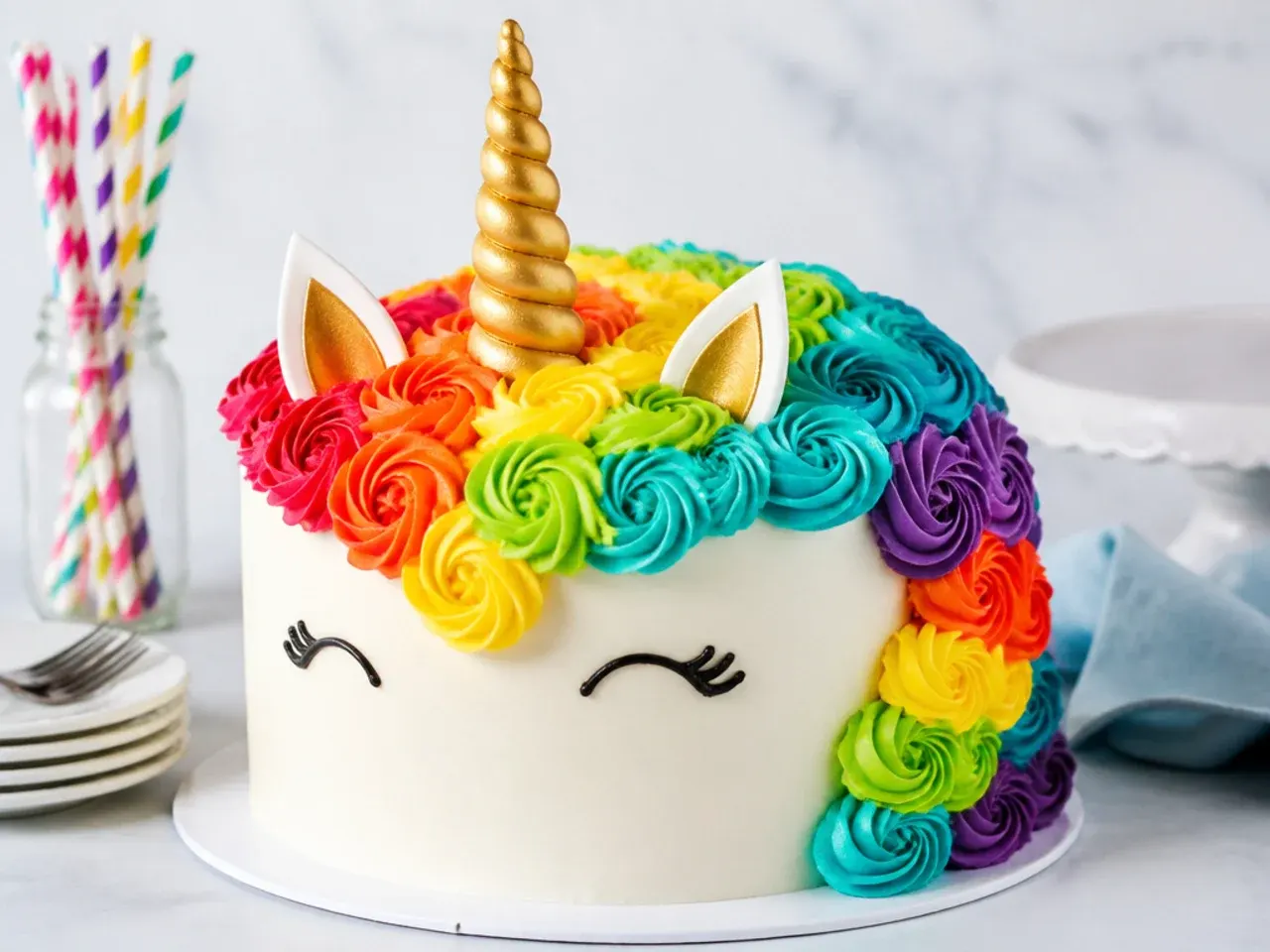 Bold rainbow mane unicorn cake with bright red orange yellow green blue and purple swirls
