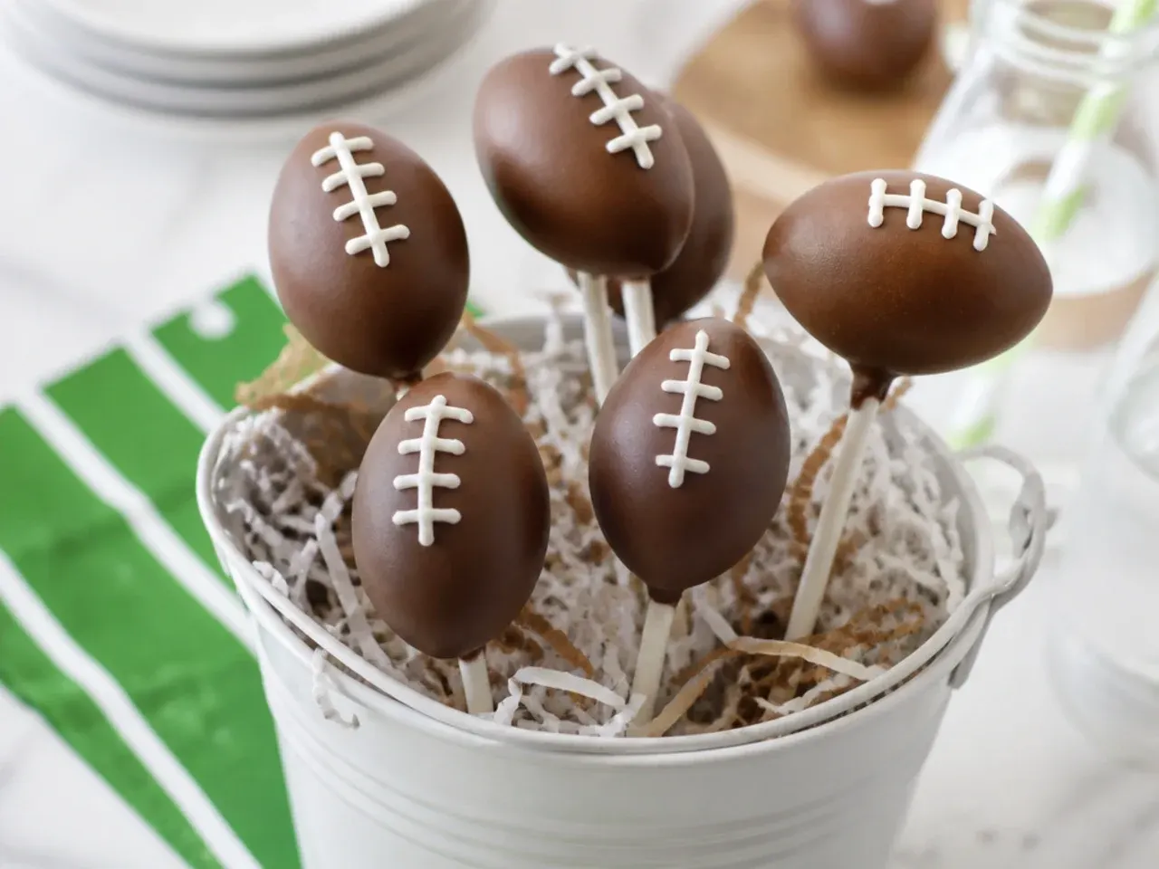 Football cake pops idea shaped like mini footballs with white chocolate laces