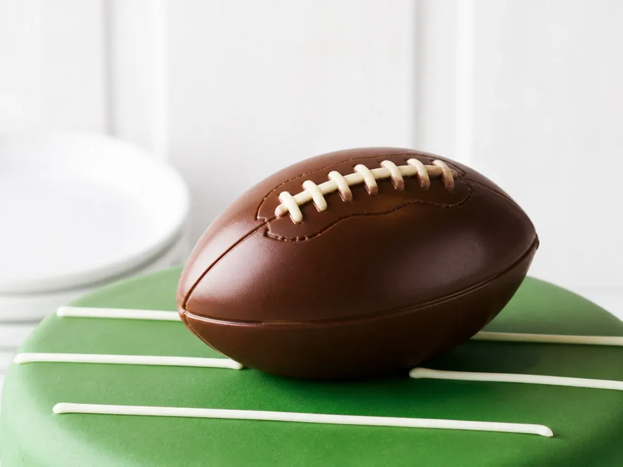 Classic molded chocolate football cake topper with a glossy snap
