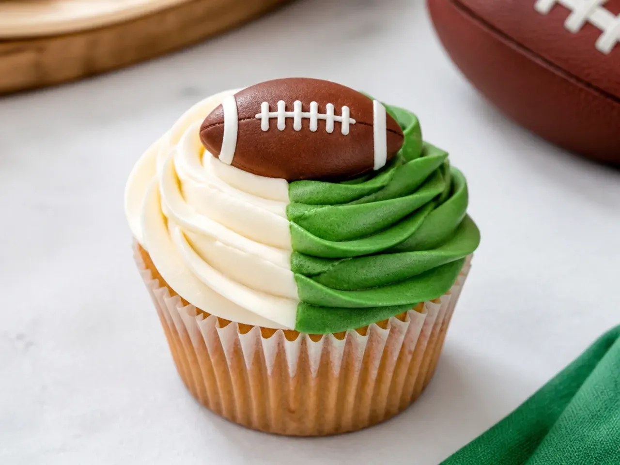 Modern two-tone football cupcakes with color-blocked green and neutral buttercream