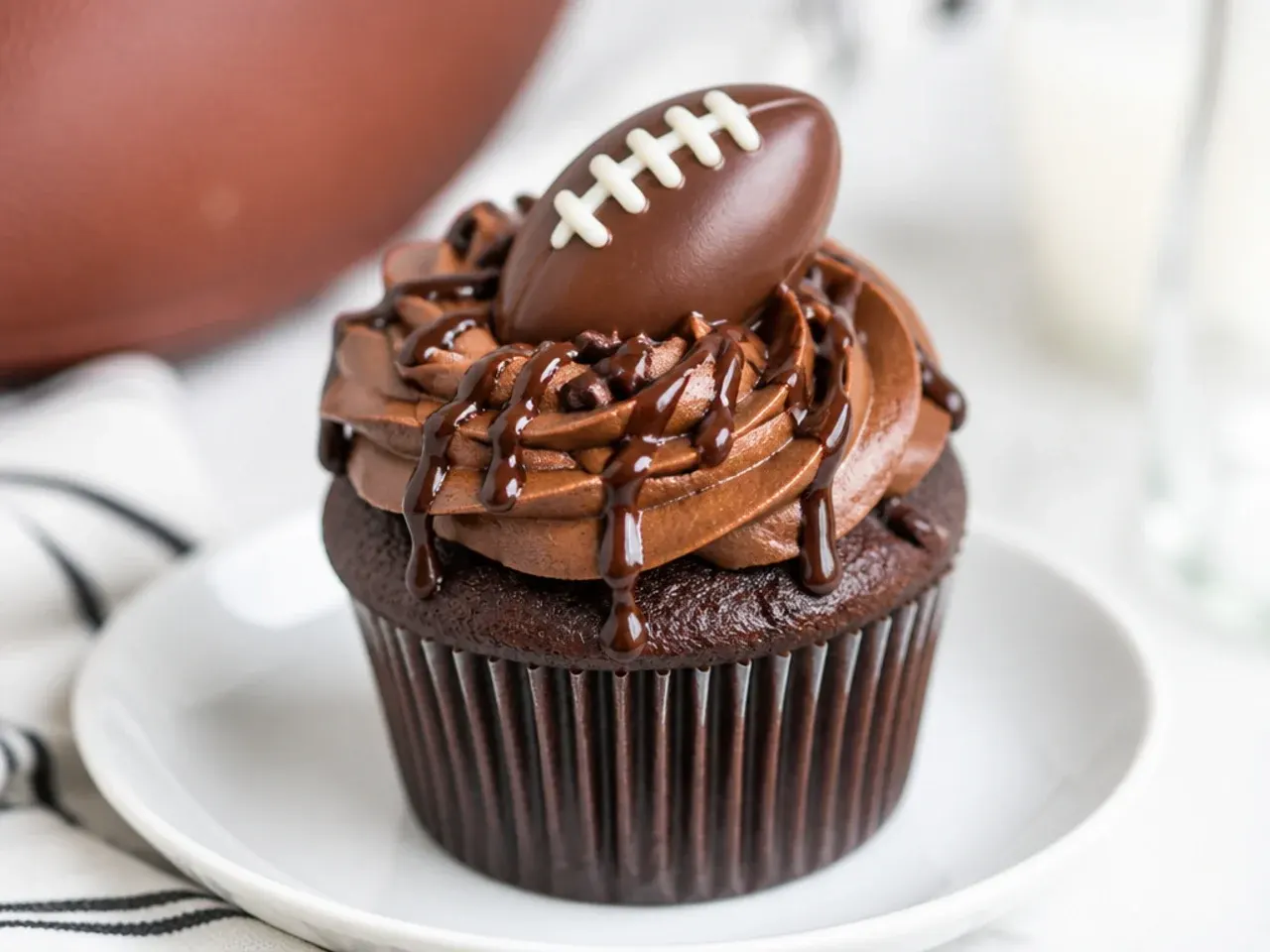 Bold chocolate football cupcakes with fudge buttercream, chocolate football and ganache drizzle