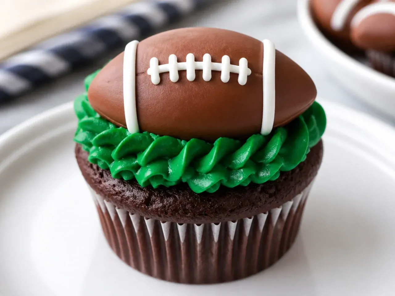 Elegant football cupcakes with uniform brown fondant footballs and neat white laces