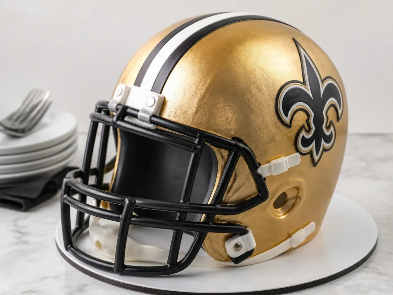 Elegant metallic team-color football helmet cake with an airbrushed champagne-gold sheen