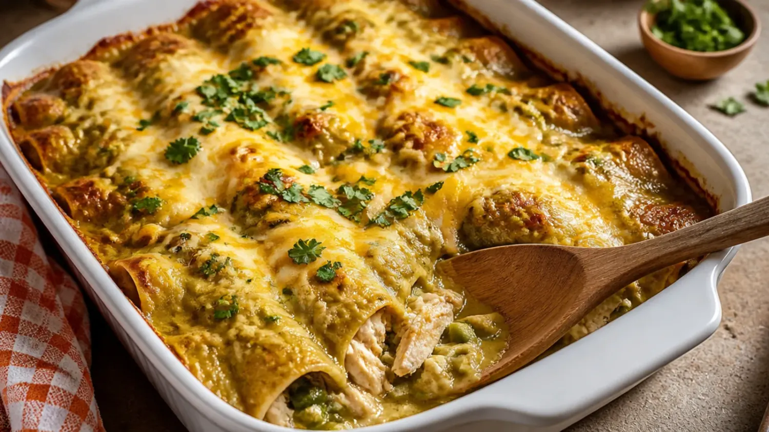 Side-by-side overhead shot of a green chili chicken enchilada casserole and a red sauce chicken enchilada casserole in matching white baking dishes