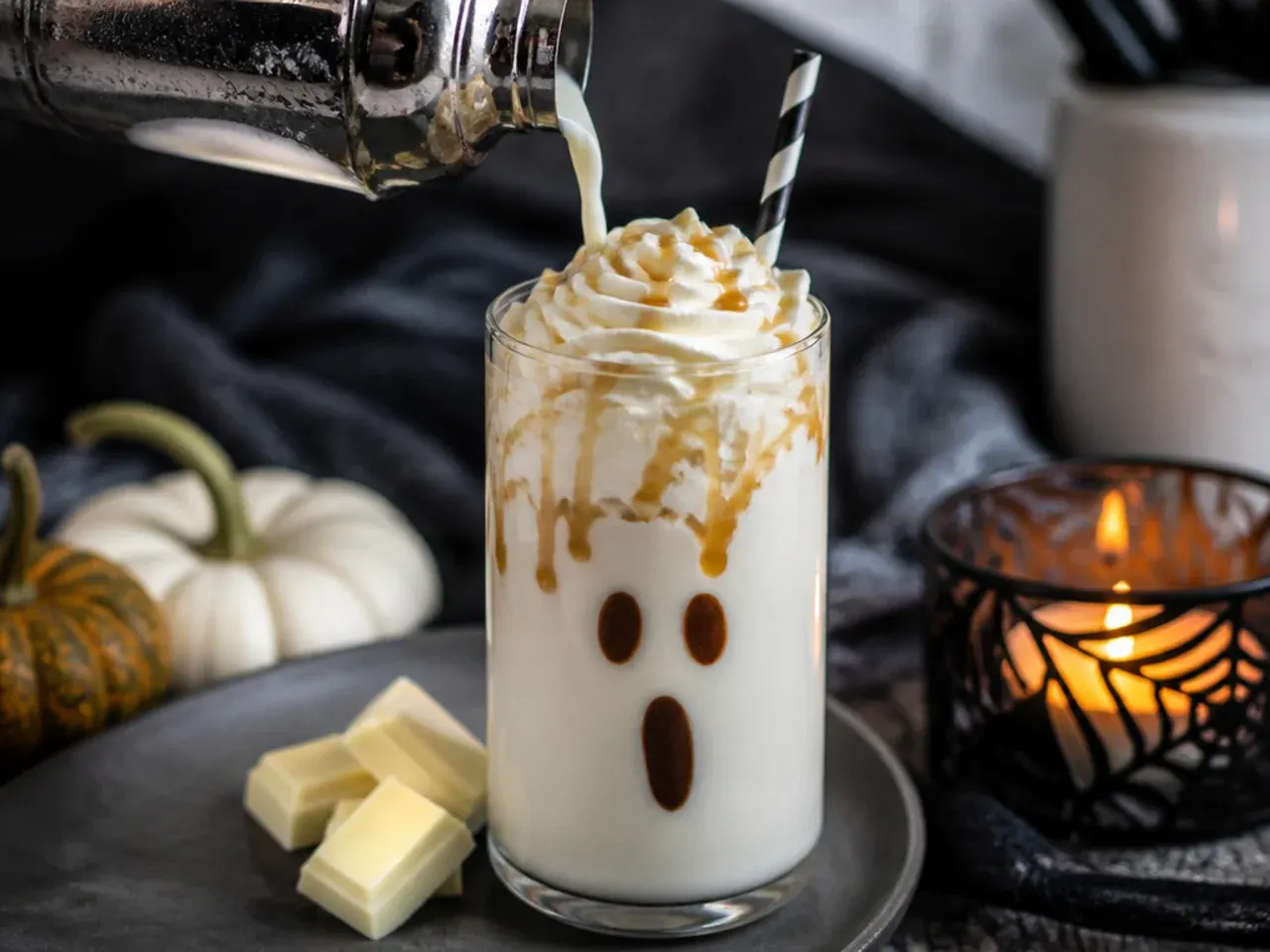White chocolate frappe topped with whipped cream decorated as a friendly ghost face.