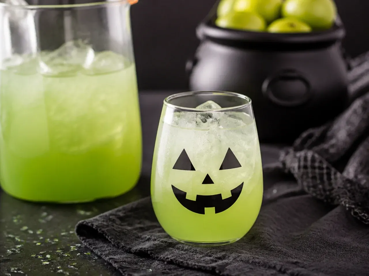 Pitchers of pre-made halloween drinks for kids lined up in a fridge ready to serve