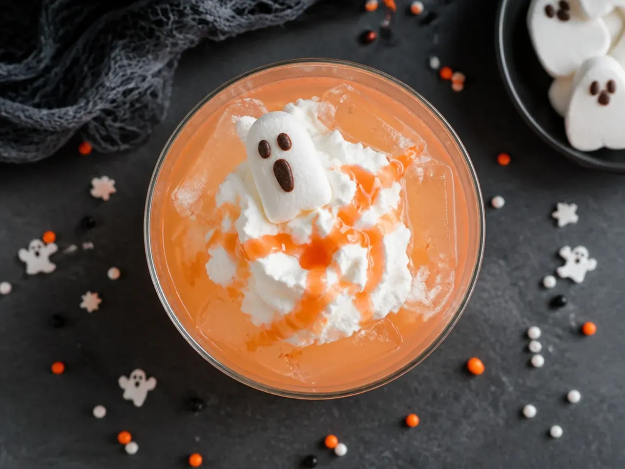 A punch bowl of pale ghost punch with melting scoops of vanilla ice cream