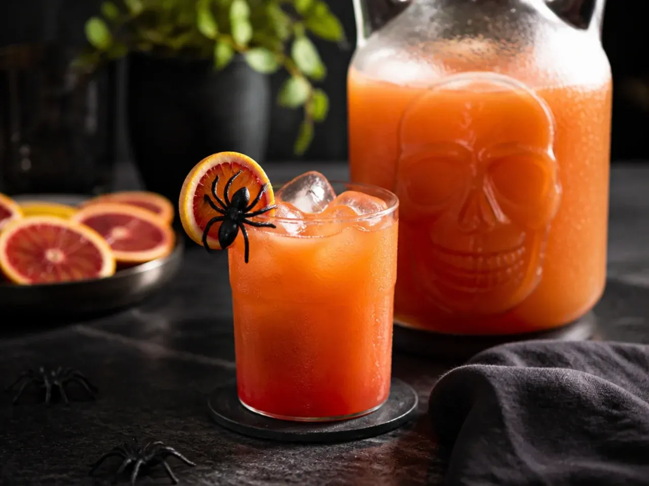 Two large jugs of pre-mixed Halloween punch base chilling in a refrigerator