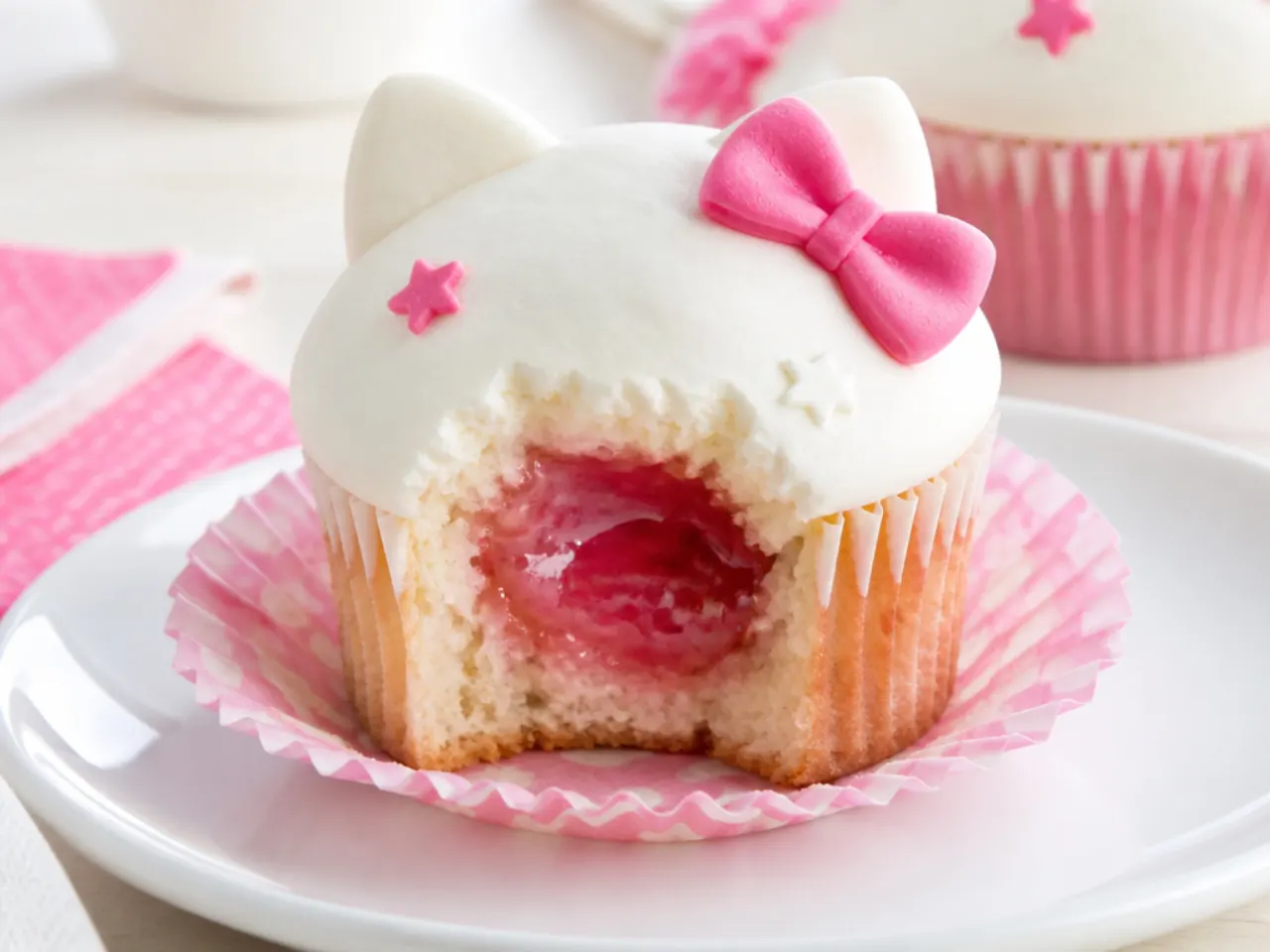 Creative Hello Kitty cupcakes with a pink jam-filled center