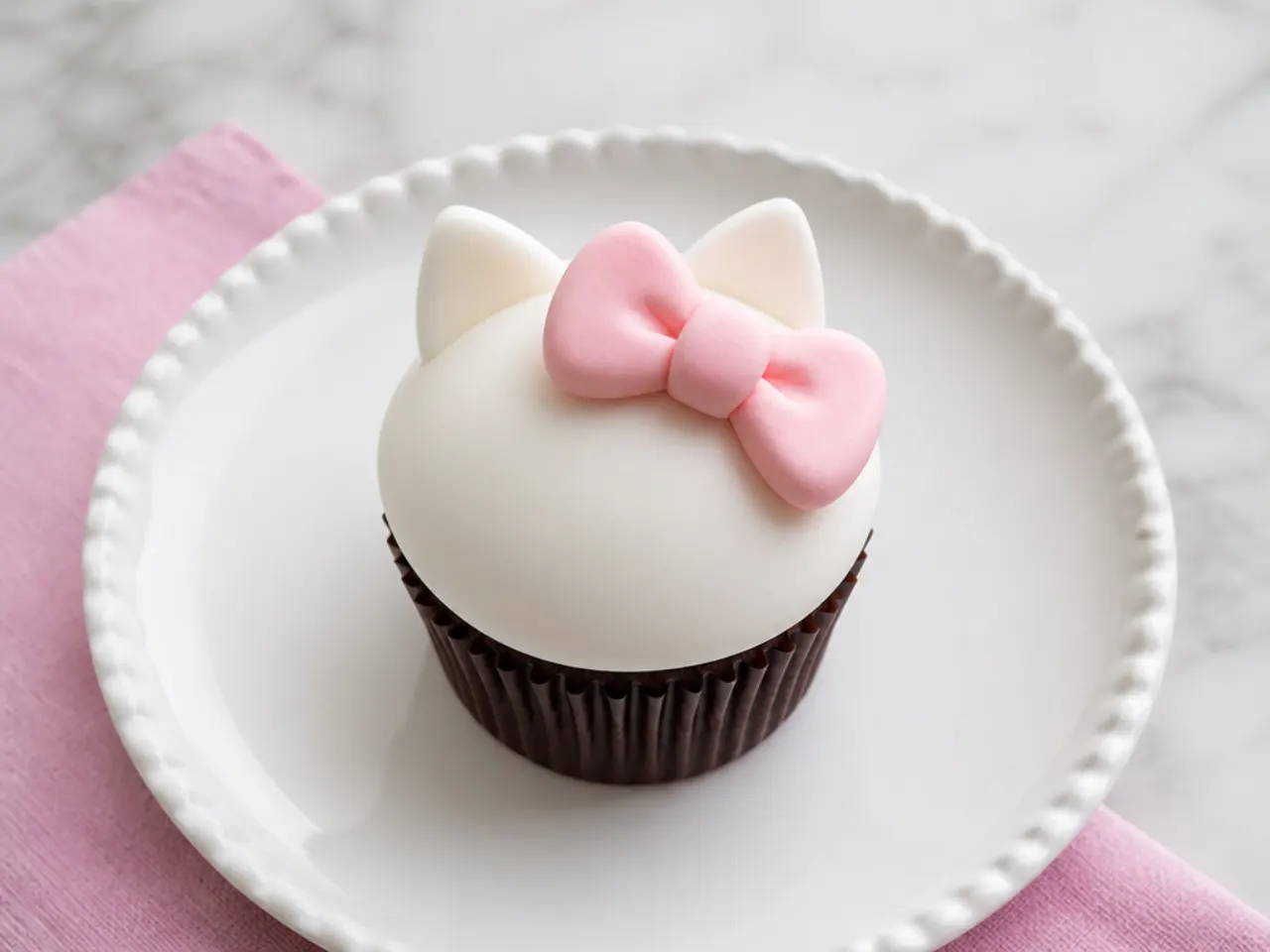 Classic chocolate-base Hello Kitty cupcakes with white bow accents