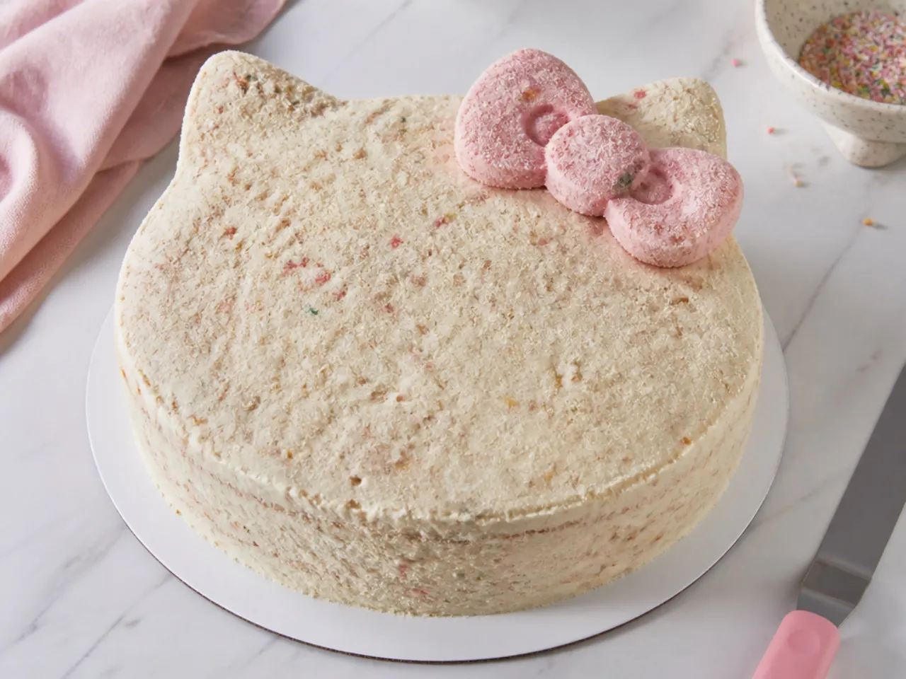 Crumb coated Hello Kitty inspired cake chilling before its final white buttercream coat