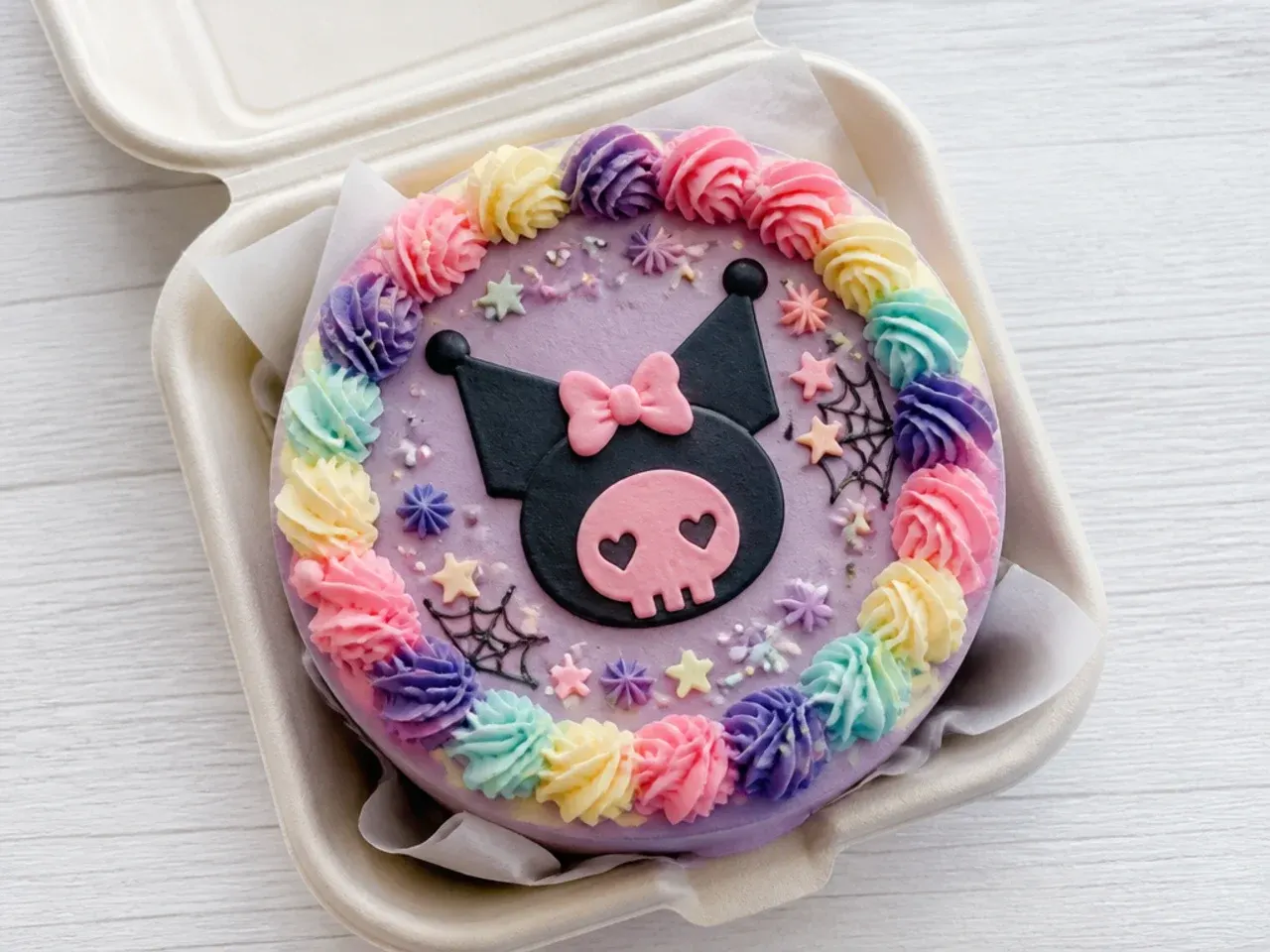 Colorful kuromi bento cake with pastel rainbow rosette border and sprinkles