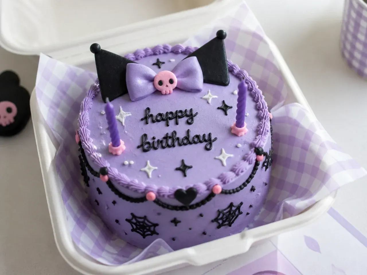 Festive kuromi bento cake with piped birthday message and purple candles