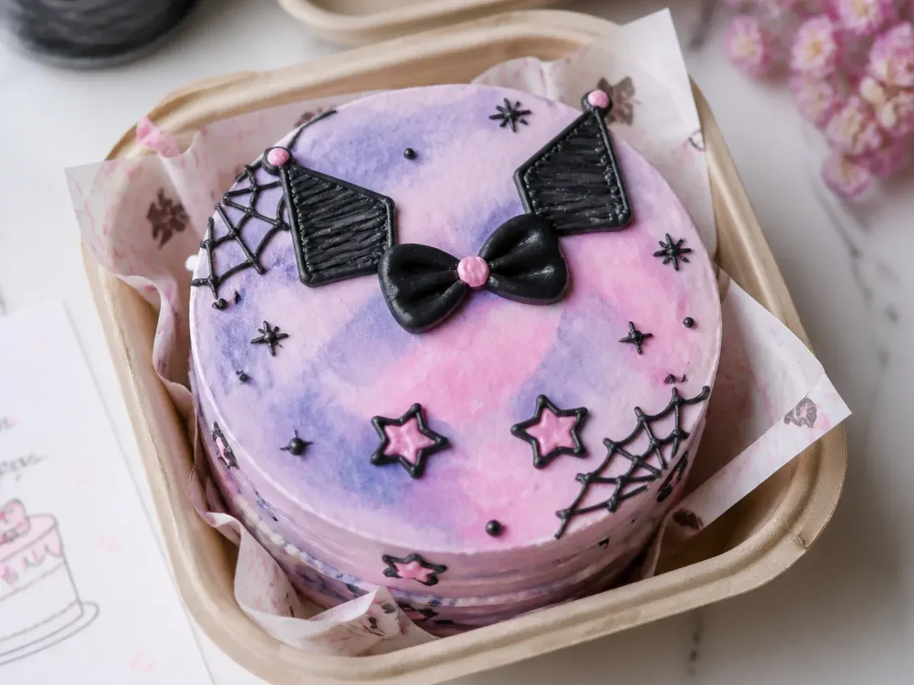 Colorful watercolor kuromi bento cake with blended purple and pink wash