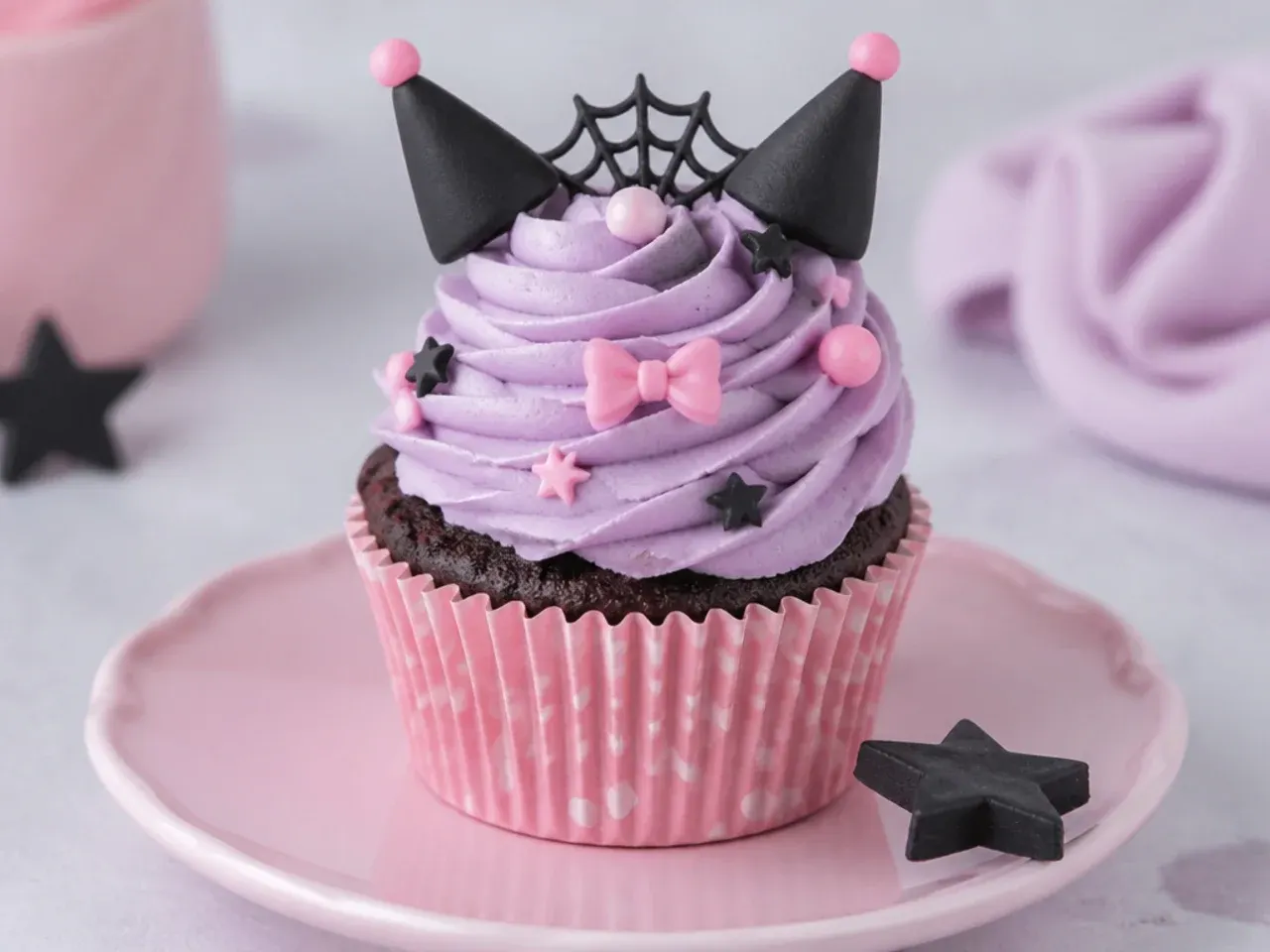 Charming Kuromi cupcakes in pink polka-dot liners with smooth lavender frosting