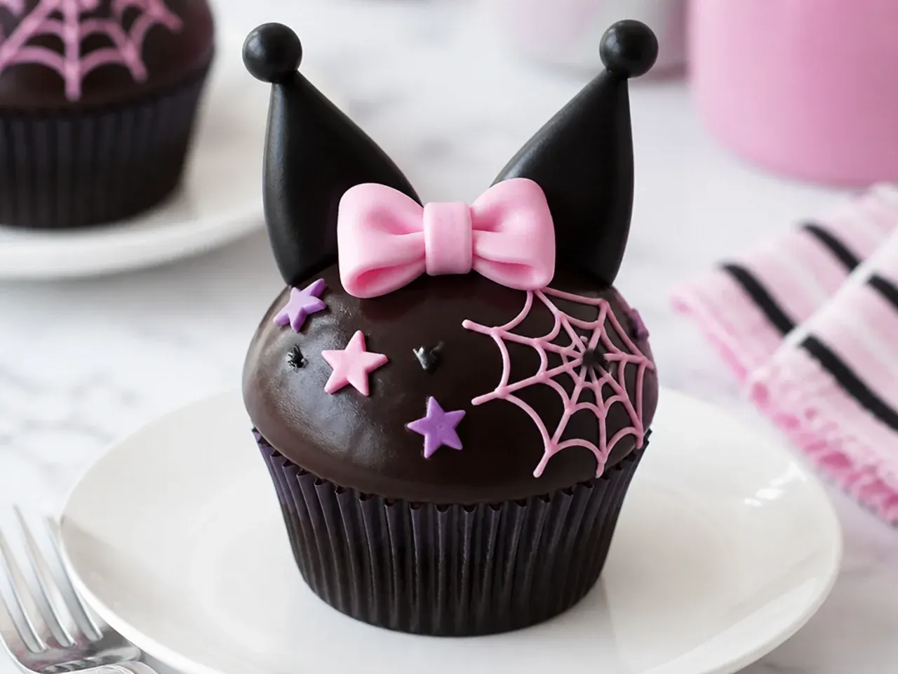 Easy Kuromi cupcakes dipped in glossy dark chocolate ganache with a pink bow