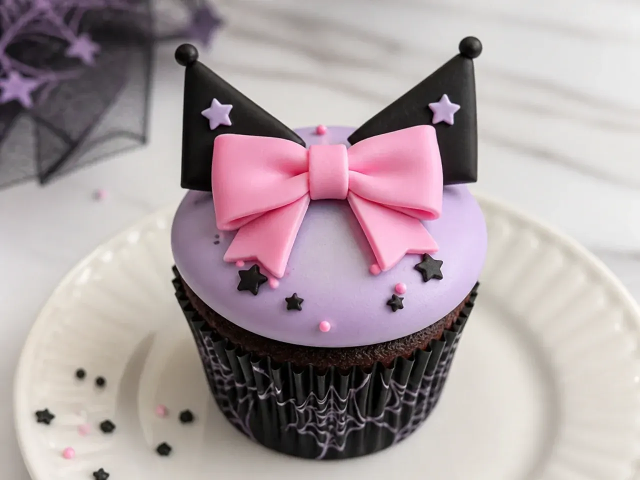 Minimal Kuromi cupcakes with one large pink fondant bow on smooth lavender frosting