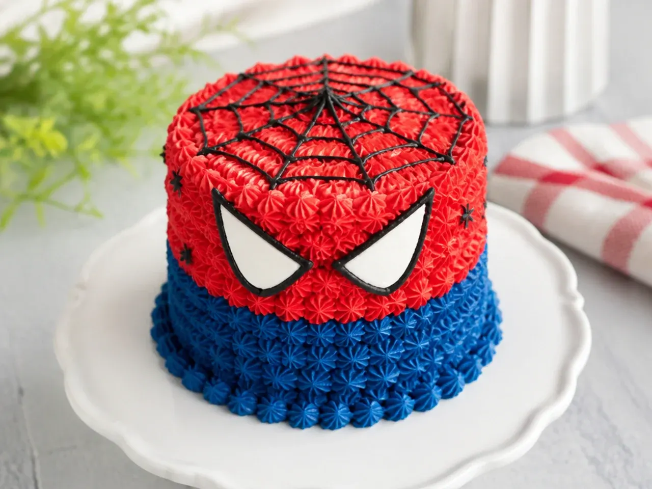 Delicate mini spiderman cake covered in red and blue piped rosettes
