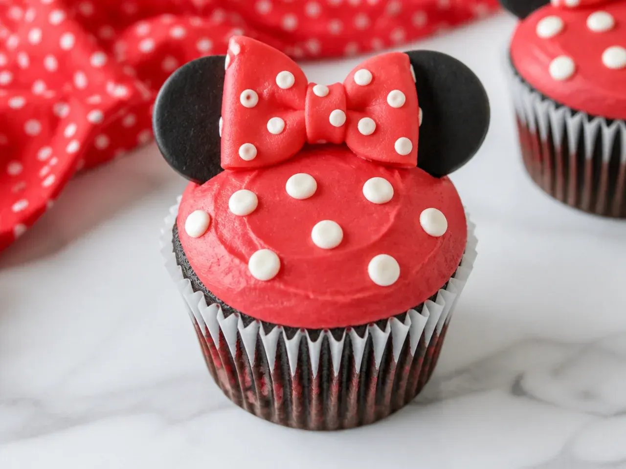 Easy no-pipe Minnie Mouse cupcakes decorated with a spatula