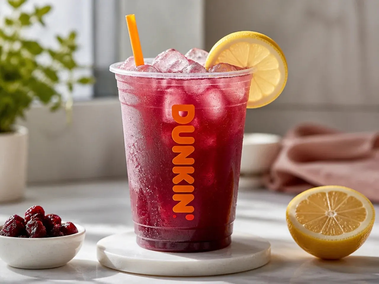 A row of finished non coffee Dunkin-style drinks garnished with fruit, mint and whipped cream on a wooden tray