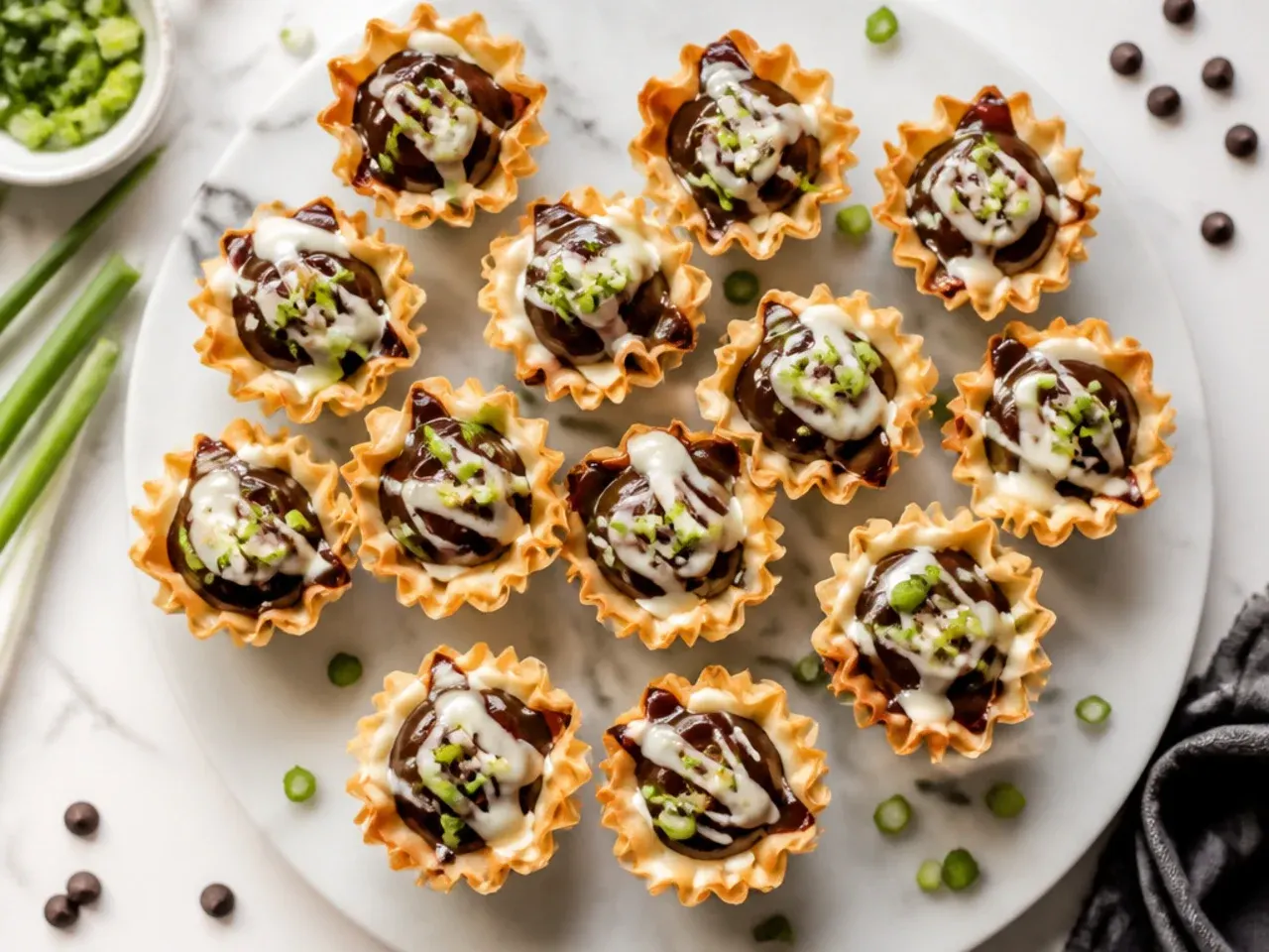 Glossy dark chocolate ganache filling phyllo cups, chilling on a tray