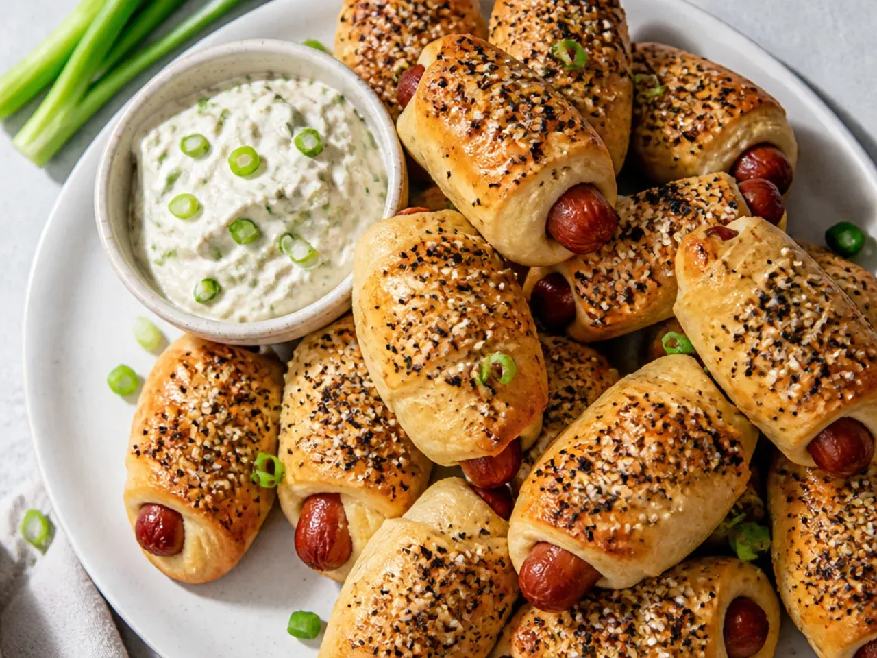 Everything bagel seasoned pigs in a blanket with scallion cream cheese dip