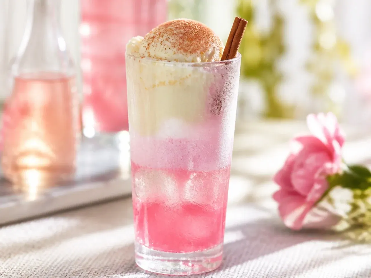 Layered pink and cream soda float with vanilla ice cream on top