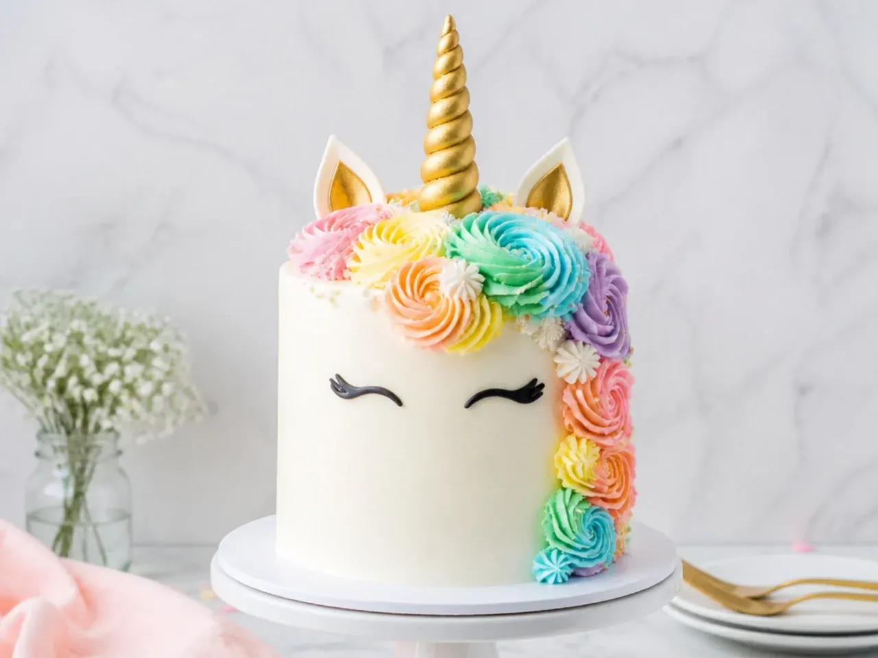 Minimal white rainbow unicorn cake with a textured white mane and gold horn