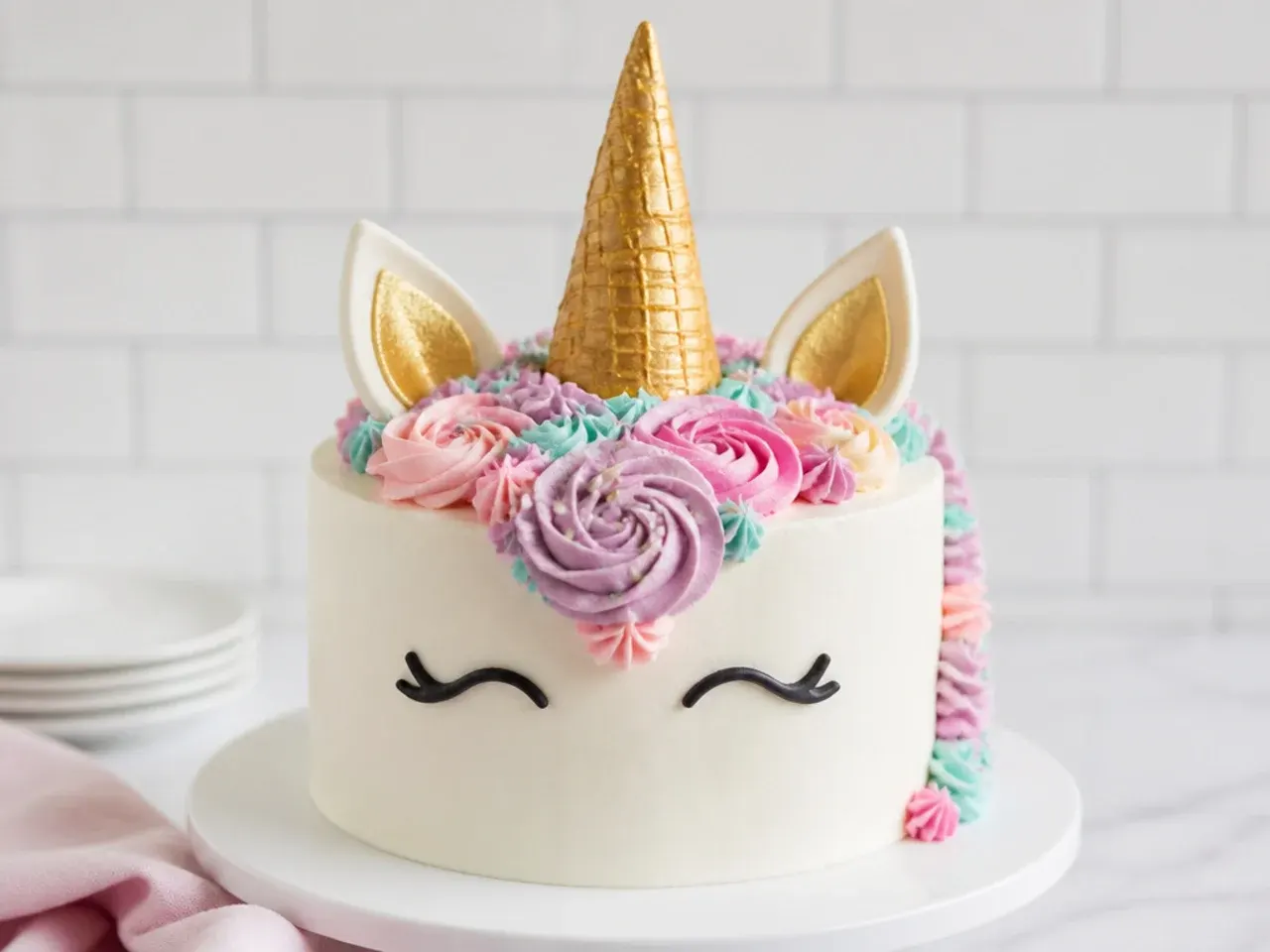 Easy unicorn cake using a gold ice cream cone as the horn
