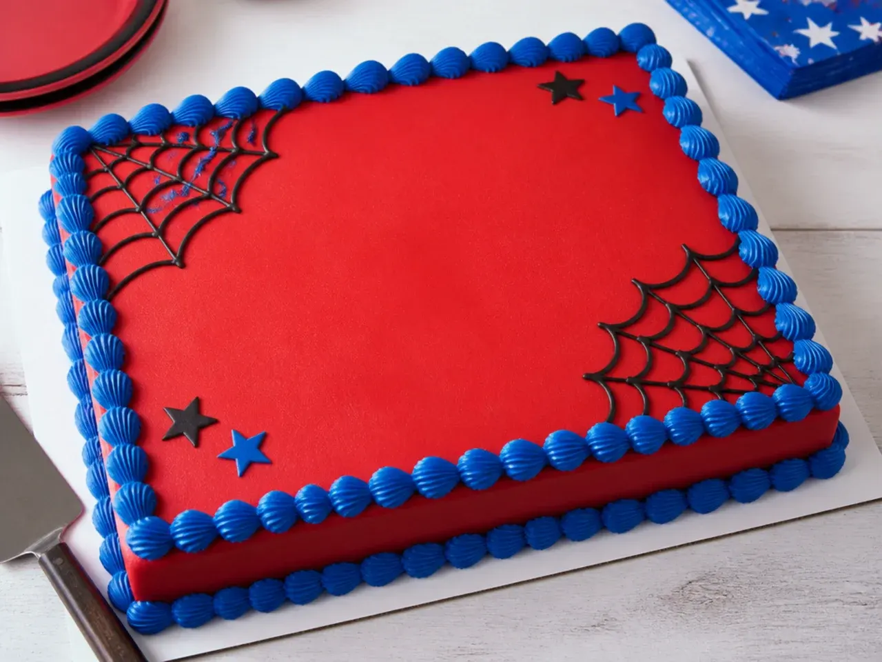 Easy spiderman sheet cake idea with corner web piping and blue shell border